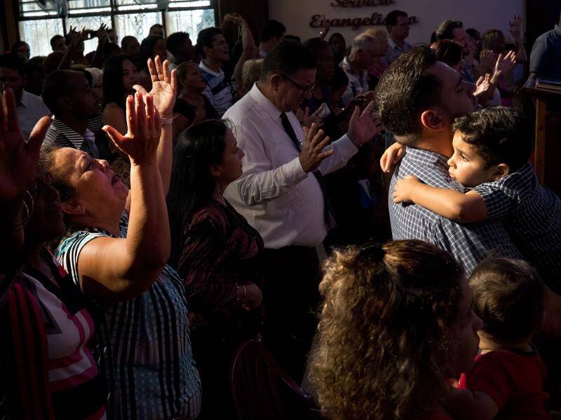 Evangelicals pray during a service in memory of the people who died in Friday's plane crash in Cuba.