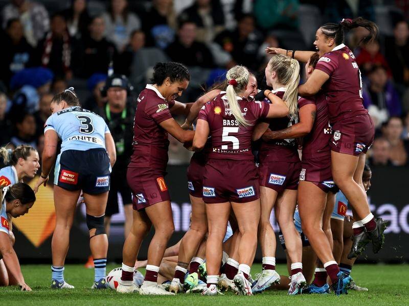 Queensland celebrate Tazmin Gray's try on their way to victory in the Women's Origin opener. (Brendon Thorne/AAP PHOTOS)