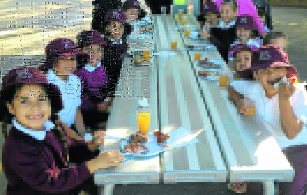 Students celebrate Walk Safely to School Day with a barbecue breakfast.