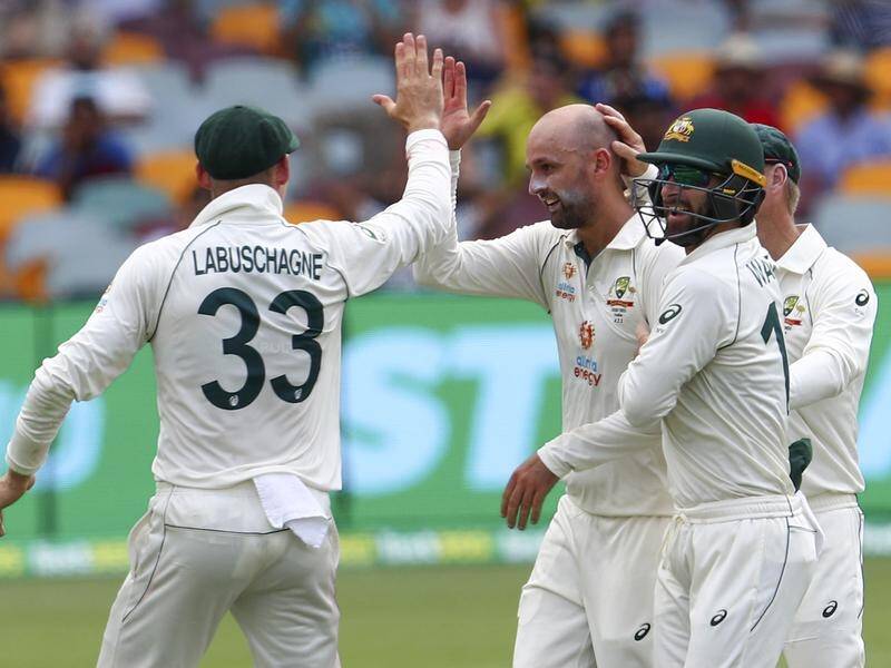 Nathan Lyon (c) followed his quickfire 24 with the bat by taking the wicket of India's Rohit Sharma.