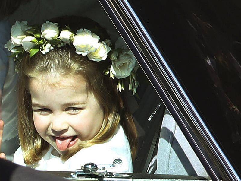 A cheeky Princess Charlotte sticks out her tongue as she arrives at her uncle Harry's wedding.