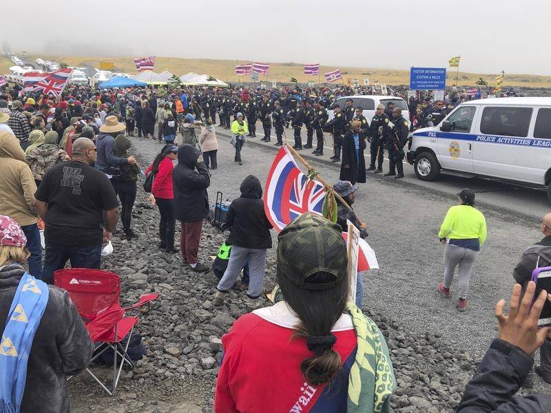Police in Hawaii face protesters trying to stop construction of a telescope on a sacred site.