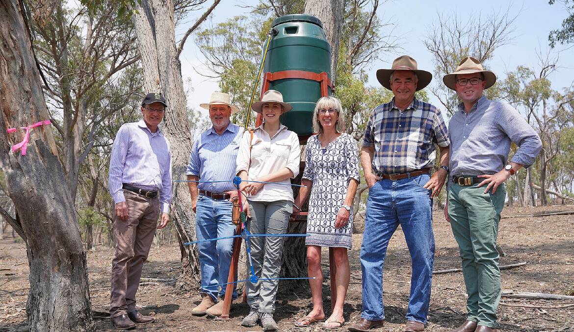 WATER: Delivered to koalas at Tilbuster by (l-r) Armidale council's general manager business Scot MacDonald, John Lemon, Zoology undergraduate Claire Chepel, Cr Libby Martin, Mayor Simon Murray and Northern Tablelands MP Adam Marshall. 