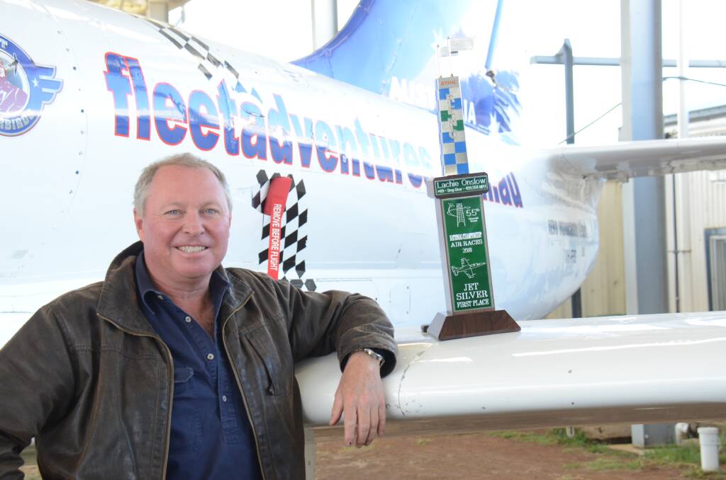 Lauchie Onslow displays this year's Jet Silver trophy on the wing of the Fleet adventure jet at Armidale Airport.