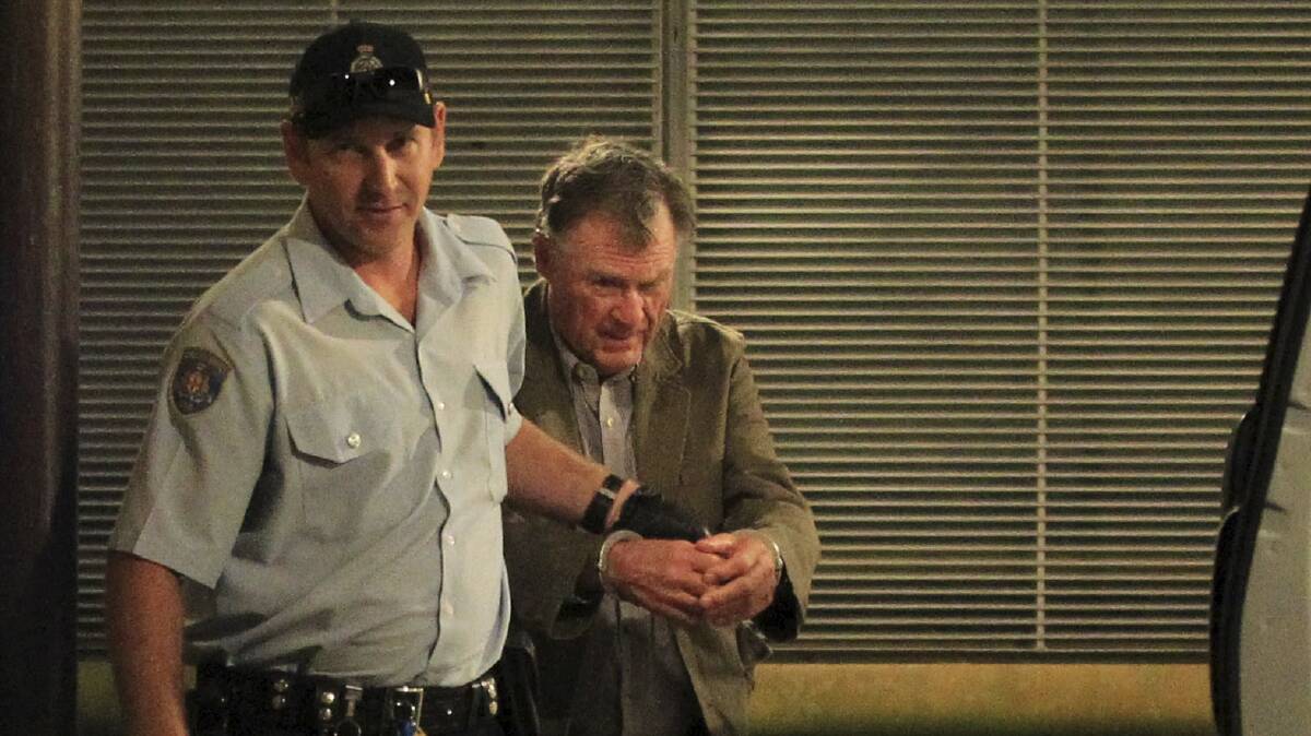ACCUSED: Ian Robert Turnbull leaves the King St Courts surrounded by prison guards. Photo: James Alcock