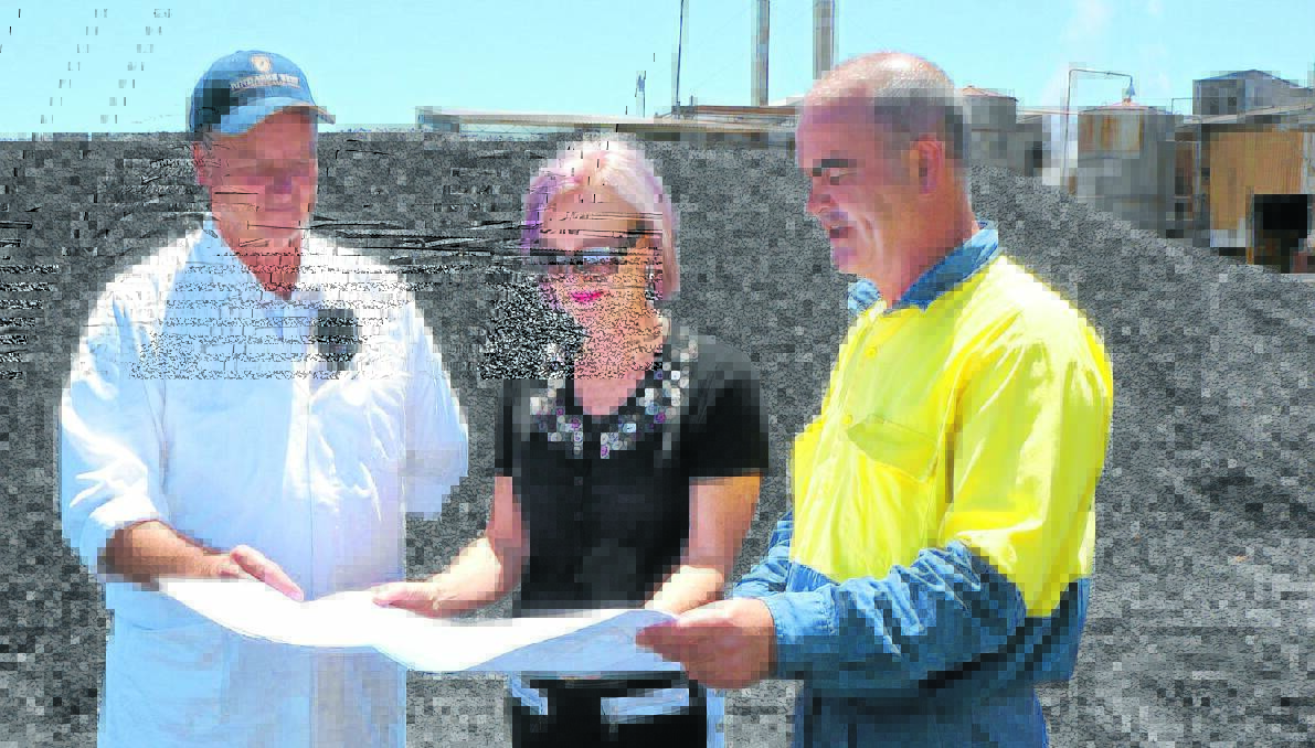 FEBRUARY START: Bindaree Beef plant manager David Richardson, left, business manager Kerri Newton and maintenance and project engineer Dave Sneddon consider the 
bio-digestor in front of the pile of coal that fuels the current power station for the abattoir. Photo: Michele Jedlicka, Inverell Times