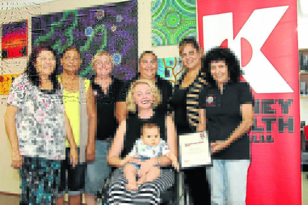ANGELIC HONOUR: Celebrating Dr Kym Rae’s Operation Angel Award from Kidney Health Australia are Aunty Rona Slater, Shirley Weatherall, Lyniece Keogh, Loretta Weatherall, Megan Naden and Aunty Pearl Slater. Dr Rae is in the centre, nursing Nayte Slater.