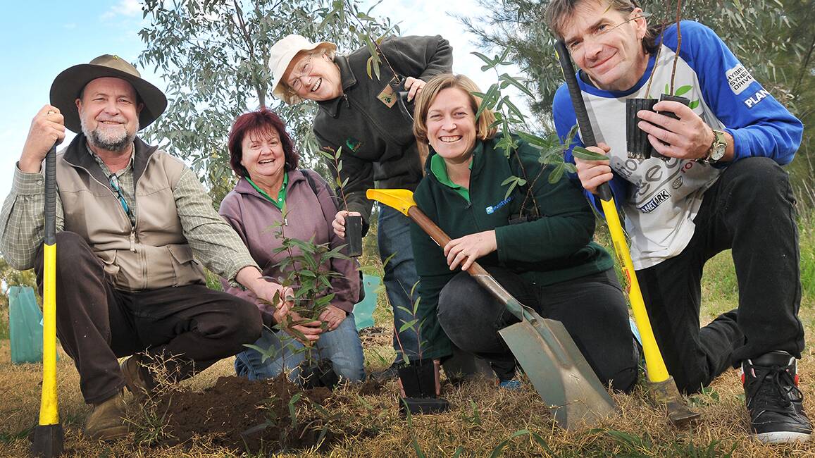 DIGGING DEEP: Members of the Tamworth Urban Landcare Group, from left, president Paul Moxon, Julie Clancy, Jean Coady, treasurer Steph Cameron and Brett Coble prepare for National Tree Day. Photo: Gareth Gardner 210714GGE01