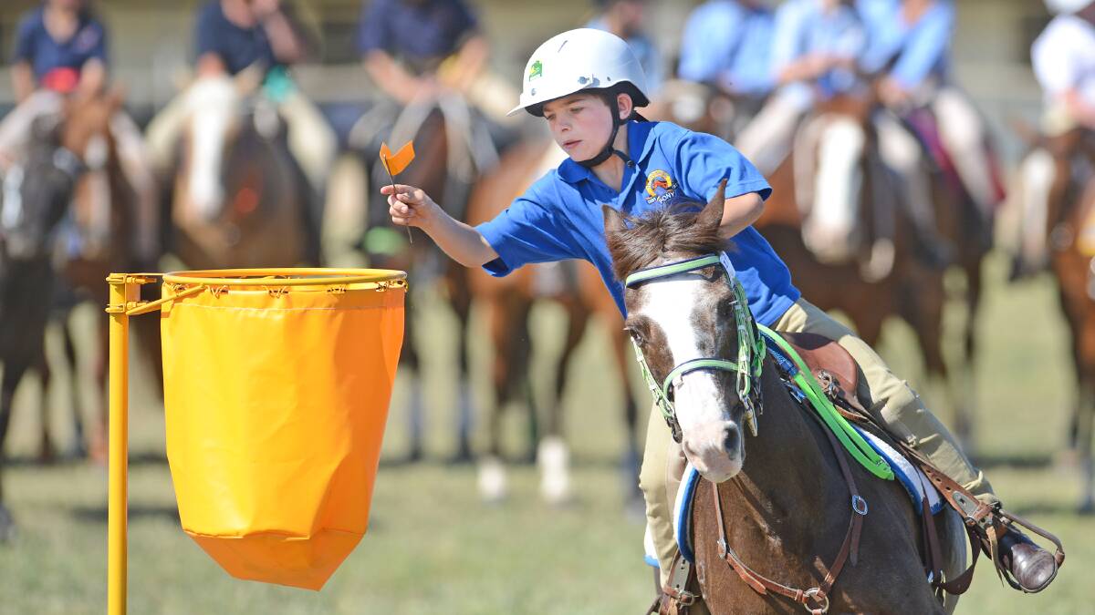 Narrabri's Rileigh Kelly riding style prepare to deposit the flag during the 9&U 11 flag event. Kelly tied with Wee Waa's William Brodigan for the overall age champion. Photos: Barry Smith 051014BSA43