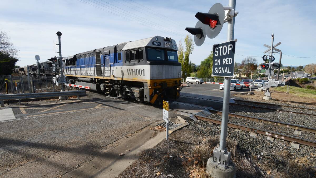 LONG LINES: Another coal train passes through the Quirindi main centre railway crossing on Wednesday.  Photo: Barry Smith 040614BSC03 