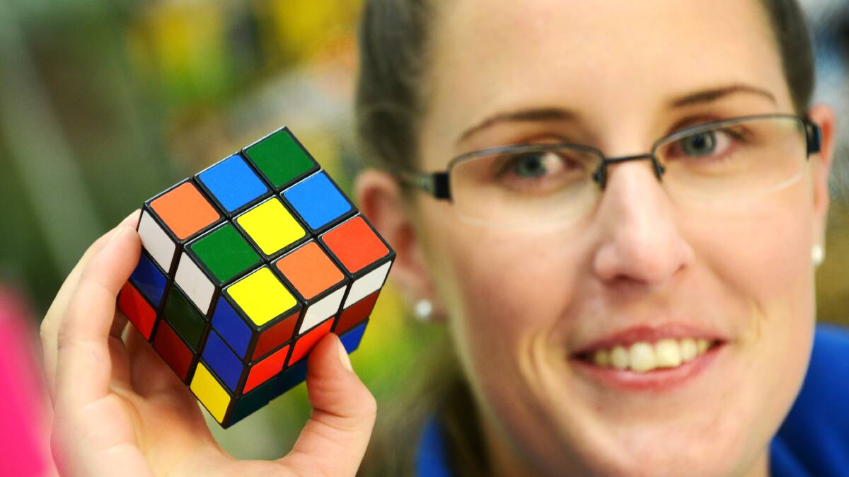 TWIST AND SHOUT: Tamworth Toy and Hobby Mega World sales assistant Brooke Urquhart poses with the ever-popular Rubik’s Cube. Photo: Barry Smith 