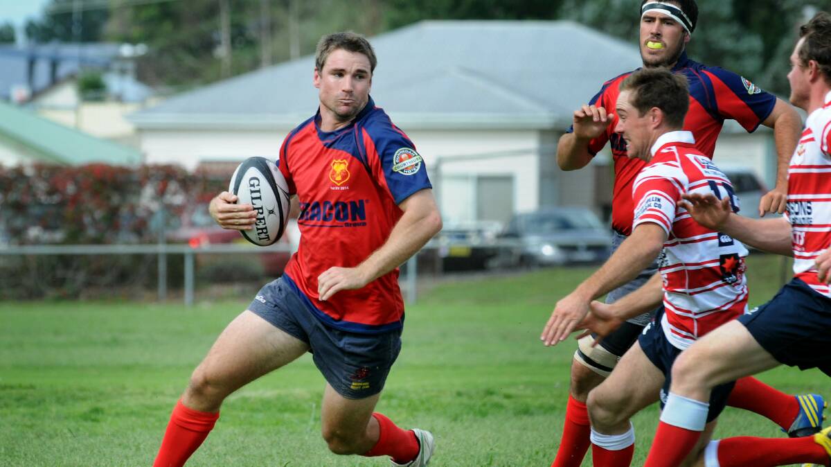 Gunnedah centre Scott Mitchell tries to evade the advancing Walcha defence back in the first round. The Red Devils backs had a lot more flow about them against Quirindi last week and will be looking to continue that tomorrow at  Barraba. Photo: Sarah Hickey