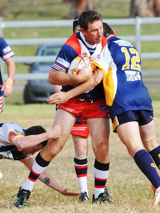 Robert Sandbrook takes a hit up and is met by the shoulder of Dungowan’s Mitch Brown during the Roosters’ win on Saturday. Photo: Geoff O’Neill 100514GOG01