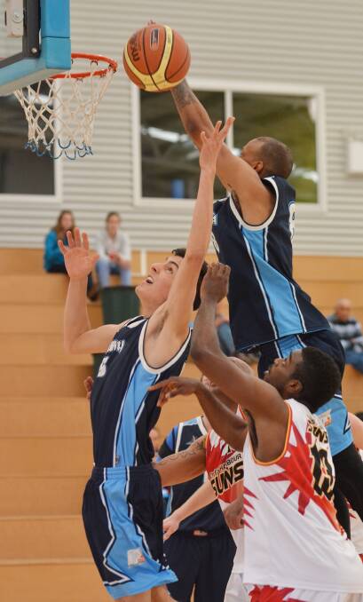 Thunderbolt import Tevin Hurd stretches to the basket for this opportunity as young forward Rhys Chillingworth (left) also goes for the rebound in 
Sunday's win over Coffs Harbour Suns. Photo: Barry Smith 100814BSE05