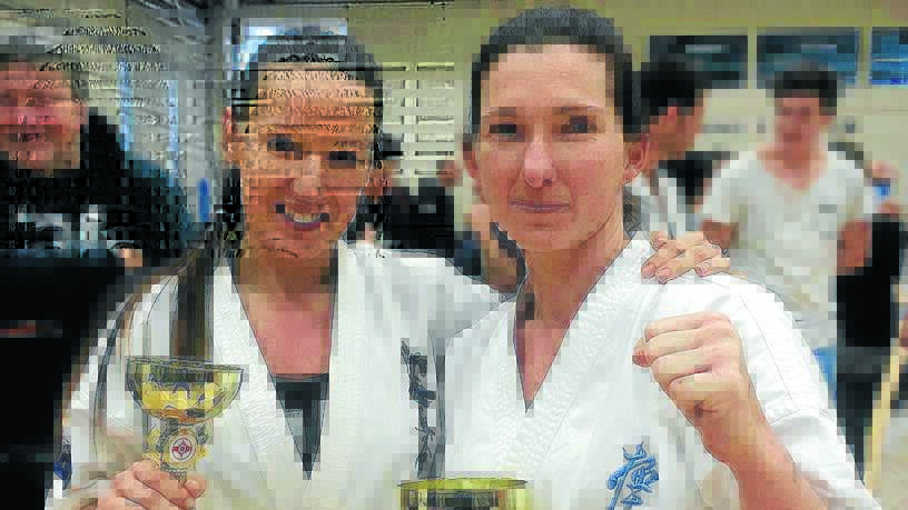 Fiona O'Neill (right) with her Australian lightweight title trophy.