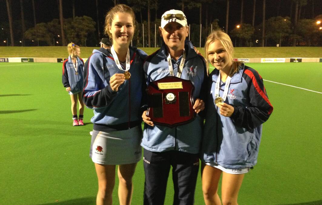 From left, the NSW U21 women’s local contingent of Georgina Morgan, Greg Doolan and Ashley Ninness with the national championship spoils.