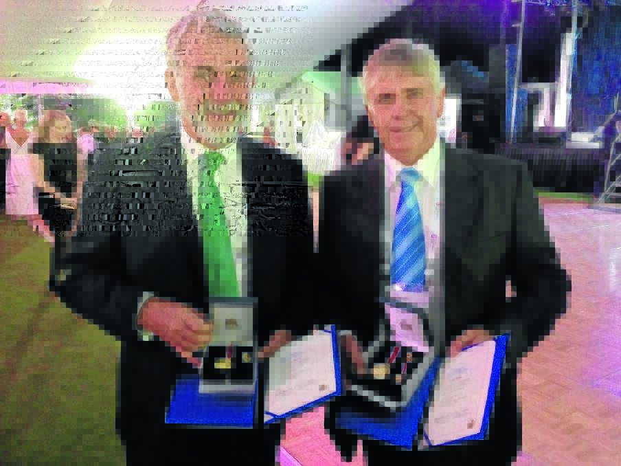 RARE HONOUR: Tamworth councillors Russell Webb, left, and Phil Betts display the awards they received at the Local Government NSW Annual Conference this week for their service to local government.