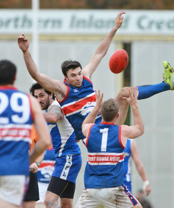 Gunnedah ruckman Al Hillard, who was the Bulldogs' best on ground, taps down this ball for Andrew George (1) as Roos ruckman Ryan Painter (left) looks on. Photo: Barry Smth 260714BSF18