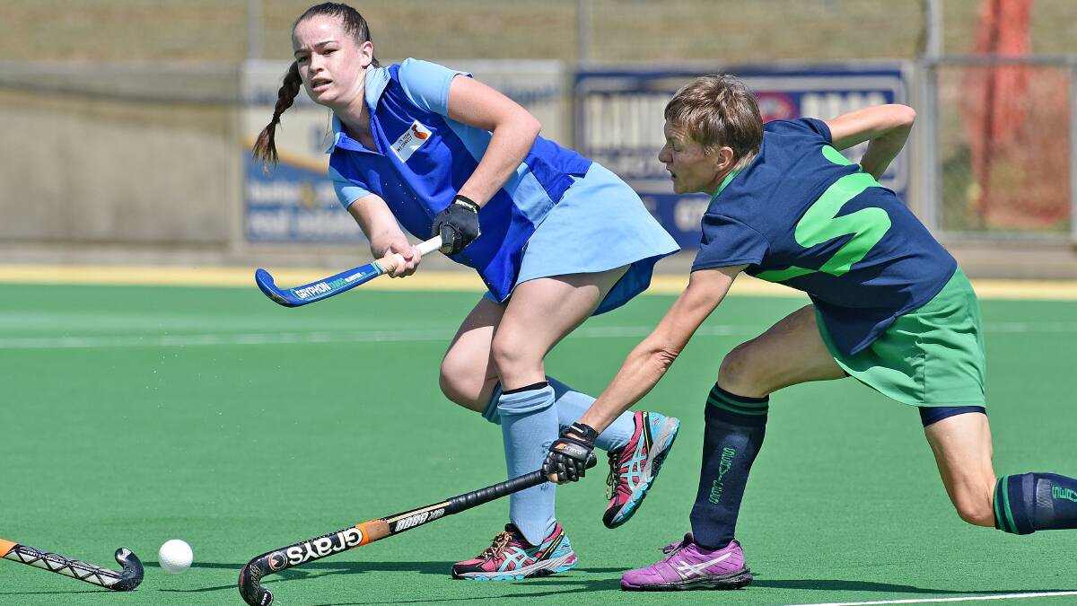 Services’ Kate Perrett and a team-mate double team to close down Olympians' Dana Constable during their clash on Sunday. Photo: Geoff O'Neill 290315GOB07