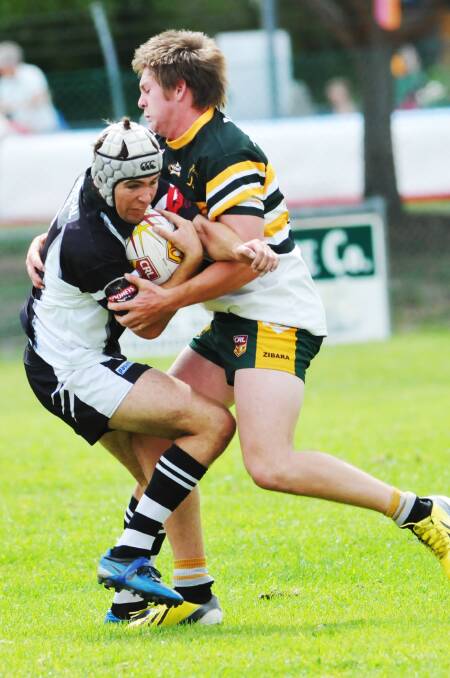 Werris Creek’s Cody Tickle (left) has his progress halted by Walcha’s Jock Abraham during the recent Pepperell Shield. Today Tickle and his Magpies tackle Manilla Tigers at Werris Creek while Abraham and his Roos host the Boggabri Kangaroos at Walcha’s Captain Cook Park.  Photo: Geoff O’Neill 150314GOB08