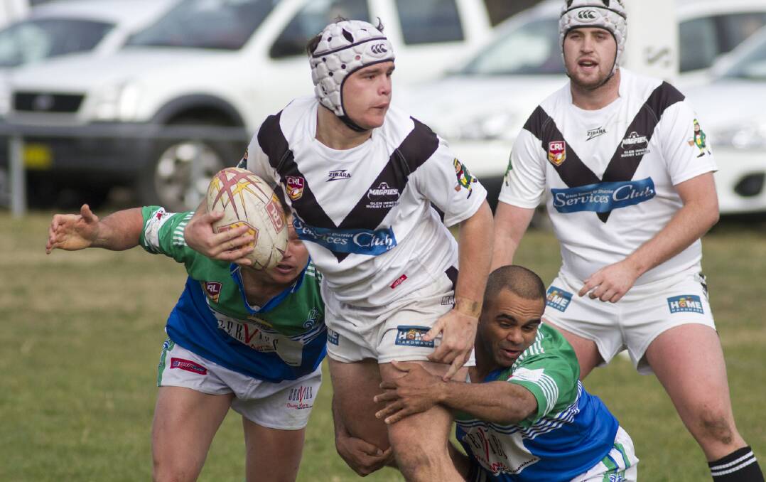 Glen Innes’s Sam Schiffman looks for support as he tries to break the tackles of his Ram adversaries in Sunday’s one-point Group 19 thriller at Armidale Rugby League Park. Photo: John Hamilton