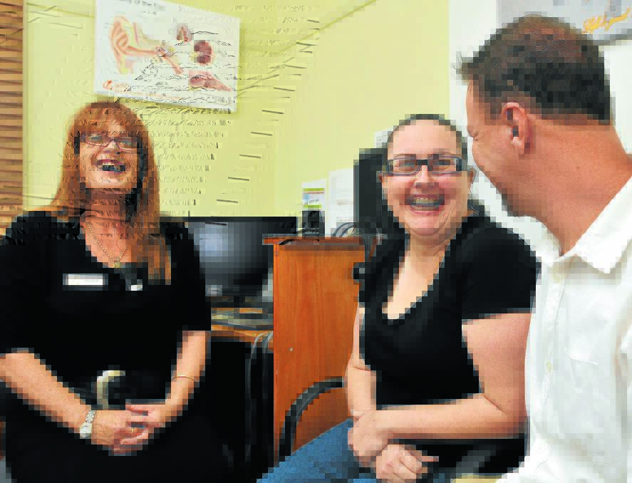 HEARING ANEW: Audiometrist Sharon King switches on a bone-anchored hearing aid for Amelia Leach, giving her the clearest sound she’s ever heard, with husband Mark Leach by her side. Photo: Geoff O’Neill 171214GOB01