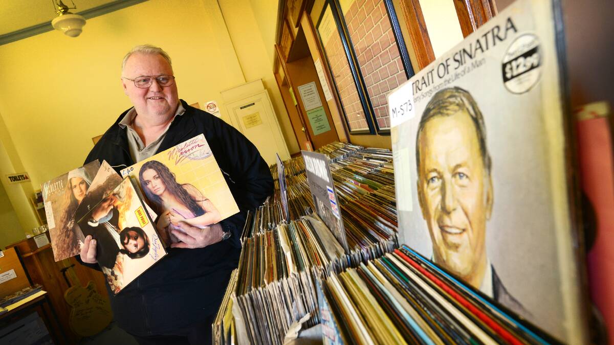 FOR THE RECORD: Australian Country Music Hall of Fame secretary Athol Latham with a small portion of the records, CDs, books and things they wish to sell before moving out. And surprisingly, they're not all country! Photo: Barry Smith 180614BSC01