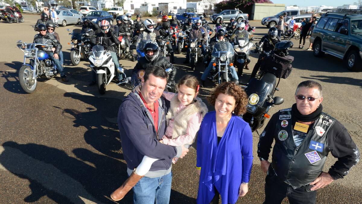 BIG ANGELS: Manilla’s Richard, holding Olivia, and Emma Coombes wave off the Adrian (Ace) Simshauser and the Guardian Angel Motorbike riders on the inaugural Ride to Ridge.