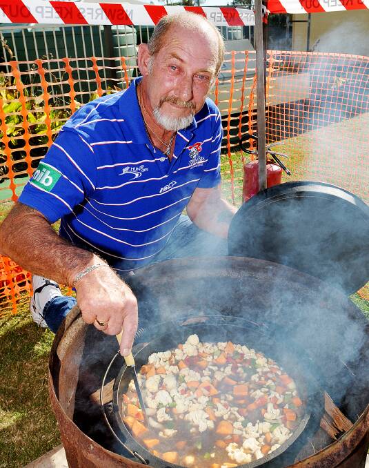 TUCKER UP: Mick Morris slaves over his camp oven during Sunday’s successful charity event at the West Tamworth Sports and Bowling Club. Photo: Geoff O’Neill 250514GOE01