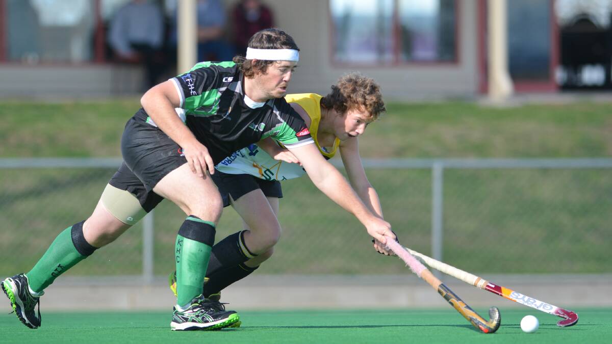 Services Workies’  Ehren Hazell and Kiwi Diggers’ Matt Jackson jostle for possession during their clash on Sunday .  Photo: Barry Smith 220614BSE05