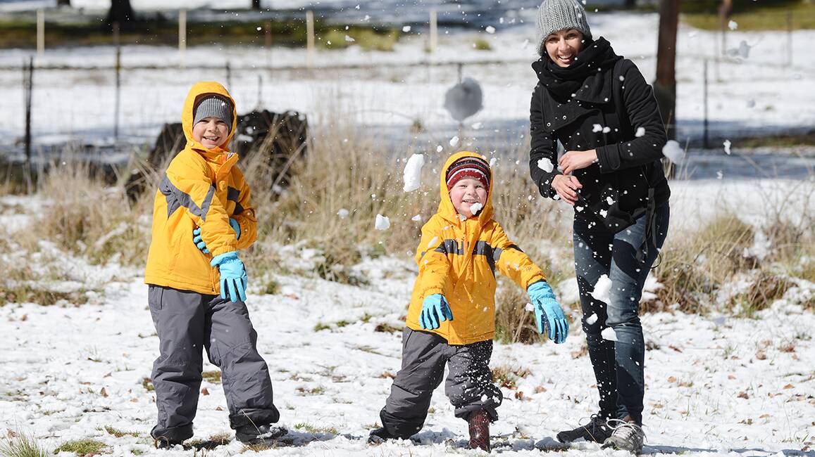 SNOW TIME: Six-year-old Cameron, three-year-old Lucas and mum Gabriela McDonald from Tamworth having a snowball fight at Hanging Rock. Photo: Barry Smith 030914BSA65