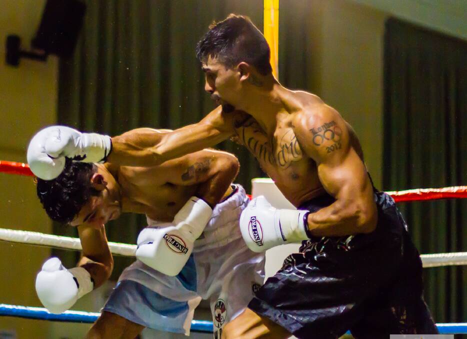 Moree’s Cameron Hammond throws a right at Argentinean Alfredo Rodolfo Blanco during his WBA Oceania Welterweight Title fight in Moree on Saturday. Photo: Downunder Boxing