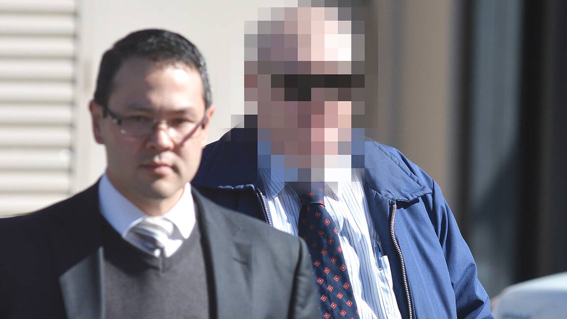 BAIL GRANTED: The former Catholic priest, who cannot be named for legal reasons, and a member of the legal team in Armidale yesterday. Photo: Barry Smith 070814BSB07