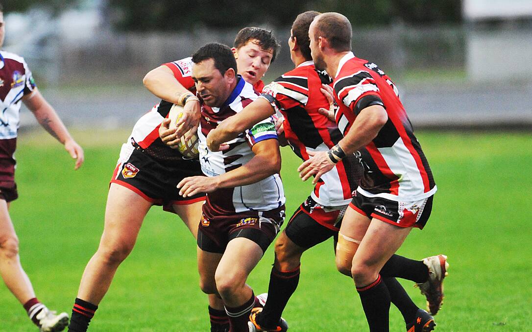 Shane Wadwell (left) and Jordan Brown try to stop Scott Hunt in last Saturday’s local derby at Scully Park with man of the match Nic Dobson (right) in support. Photo: Geoff O’Neill 150614GOF07