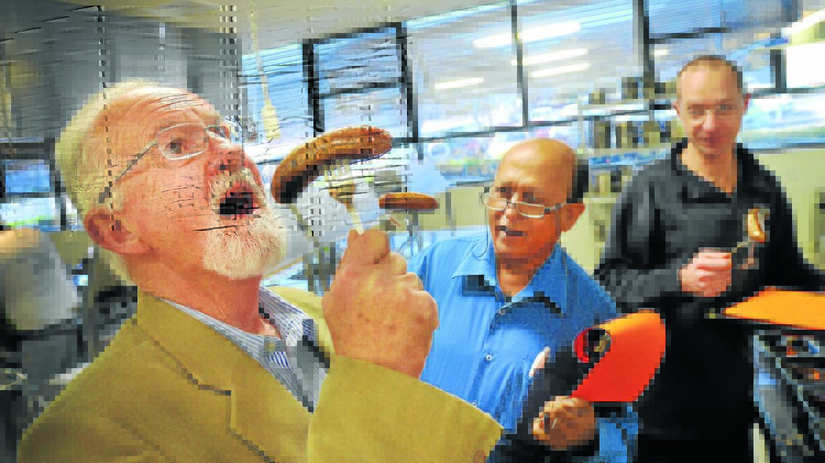 GOT SOME BITE: Hospitality TAFE teacher Ron Lightfoot tastes one of New England’s finest sausages while fellow judges Azam Ali Khan from Cascada Kitchen and Anders Jones from the Powerhouse look on.
Photo: Gareth Gardner 130814GGB01