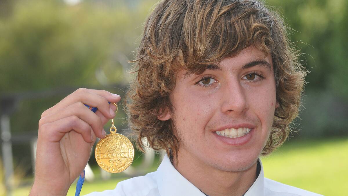 McCarthy swim star Jayden Gimbergh with his NSW All School gold. He is about to travel to the Pan Pacific Games in New Zealand to play water polo. Photo: Geoff O’Neill 090514GOE01