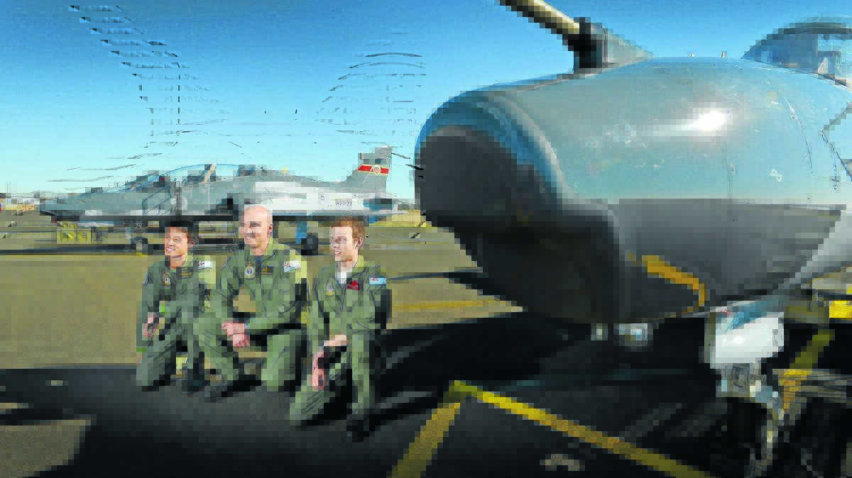 JETS TAKE OVER: Exercise Southern Lights with RAAF Hawk 127 Lead-In Fighter pilot training in Tamworth with Pilot Officer Kester Fong, Squadron Leader Jay Tuffrey and Flying Officer Nathan Segal. Photo: Barry Smith 060814BSD05