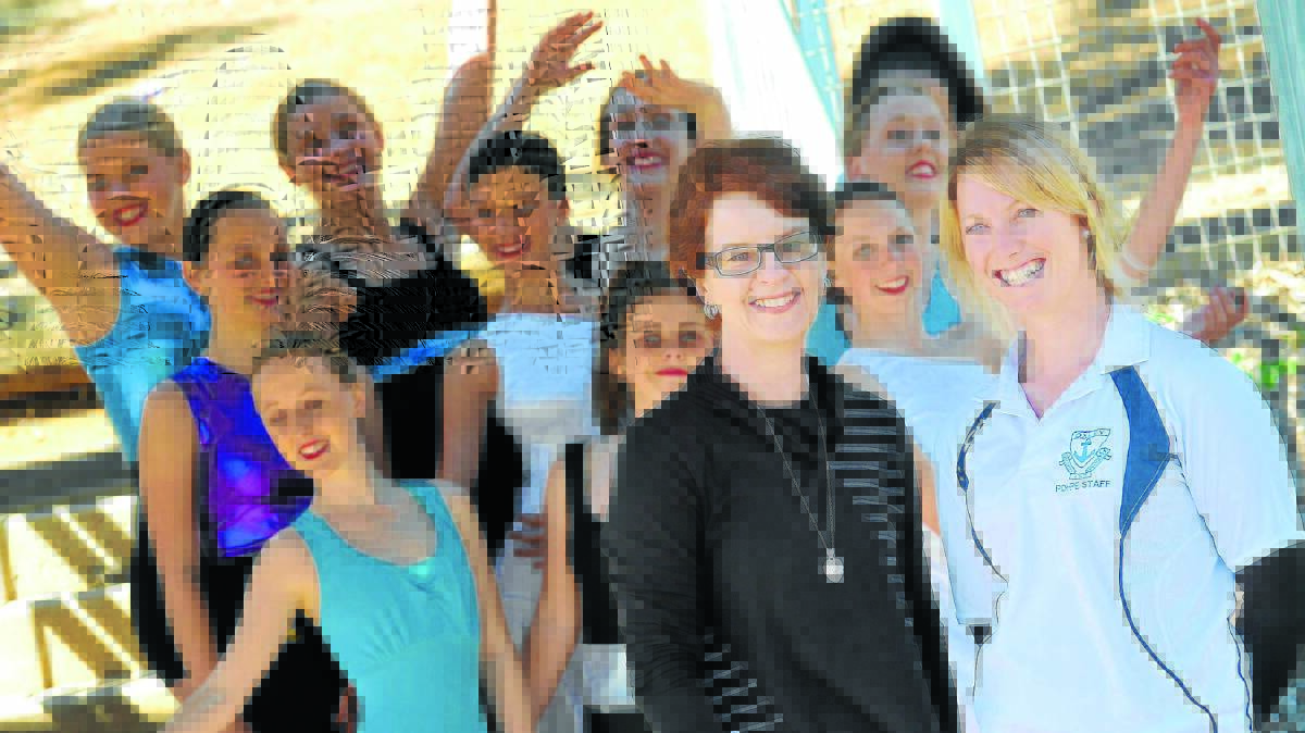 SCHOOL SPIRIT: Co-ordinator Christine Massey and Bindy Hodgson with some of their dance festival participants at Oxley High School. 070814GGC01