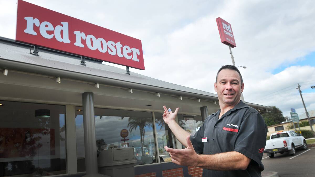 COLOUR CORRECTED: Red Rooster Tamworth franchisee Tony Bishop with the fast food outlet’s new ‘colour correct’ red signage.  
Photo: Gareth Gardner 050514GGA03
