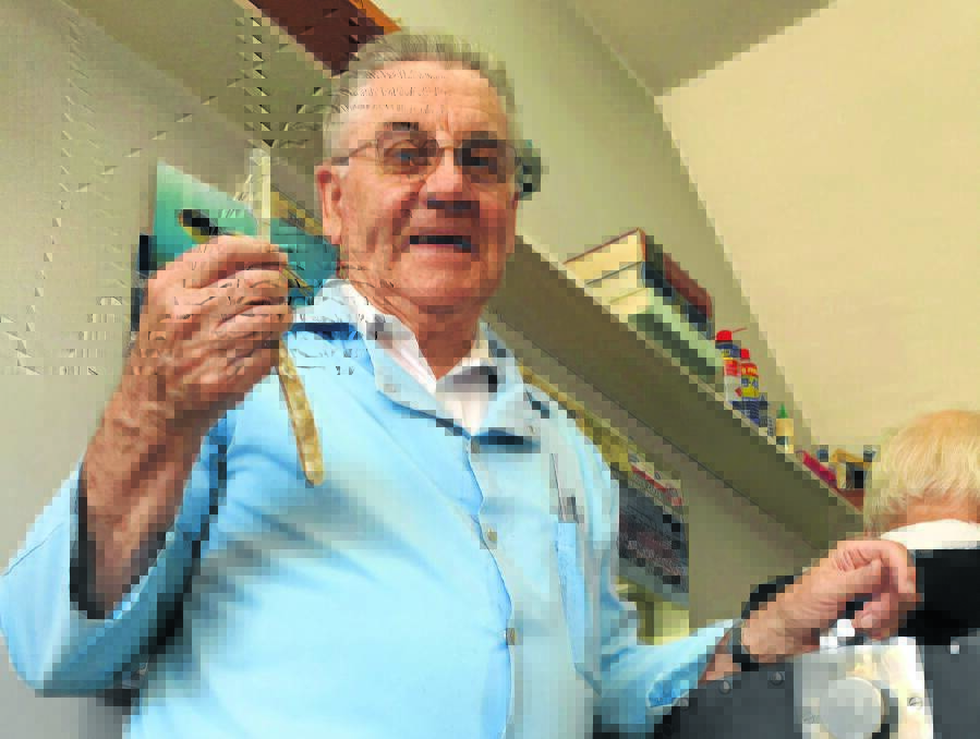 A CUT ABOVE: Armidale barber Roy Cowley is still plying his trade, 65 years on. Photo: The Armidale Express