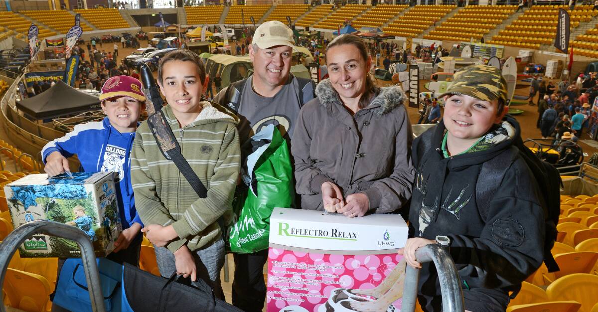 FAMILY OUTING: Eight-year-old Lucas, 11-year-old James with dad Geoff and mum Merissa and 10-year-old Daniel Tait, all from Glen Innes, shopped up big at the expo. 090814BSB08