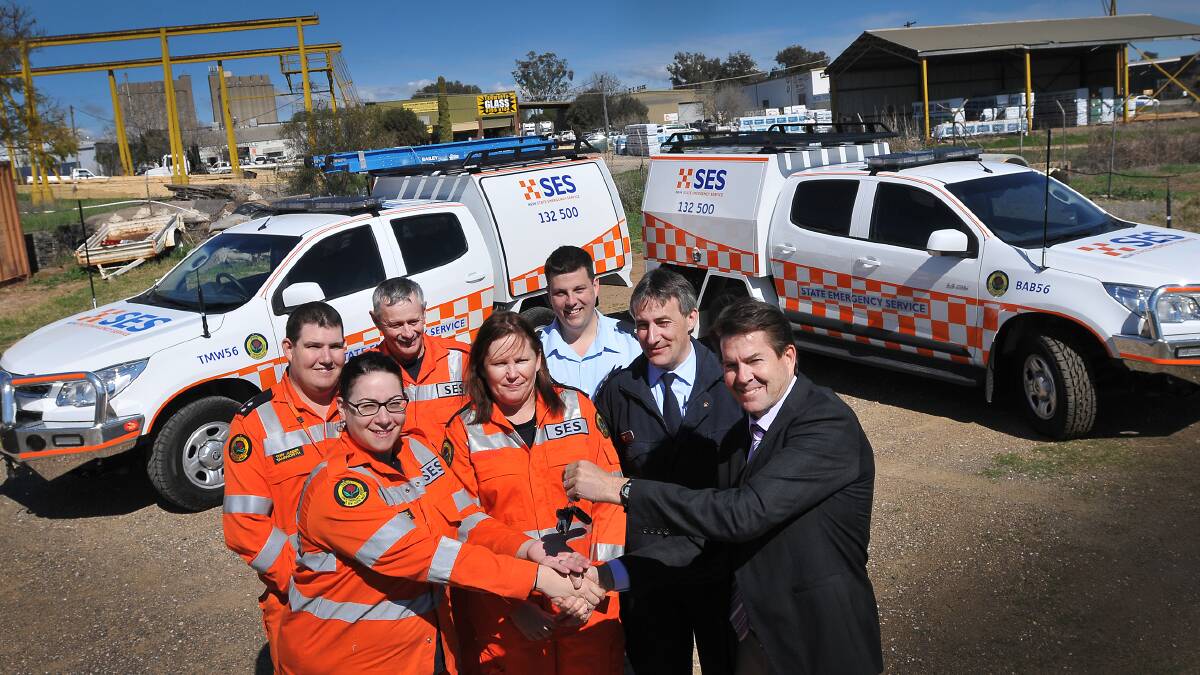 TAKING DELIVERY: SES crews from Barraba and Tamworth, including pictured back row from left, Toby Jaeger, Andrew McGregor, Heath Stimson, and front from left, Linda Bridges and Barb McGregor collect the keys from controller Andrew Galvin and MP Kevin Anderson.  Photo: Gareth Gardner 010914GGB01