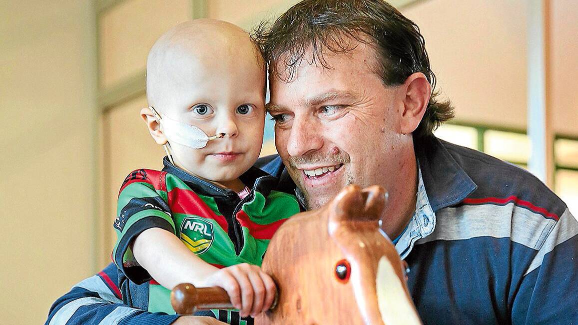 FIGHT OF HIS LIFE: Bailon Johnson and dad Randy at Ronald McDonald House in Newcastle last August. Little Bailon is facing a fresh battle after being diagnosed with two new tumours.