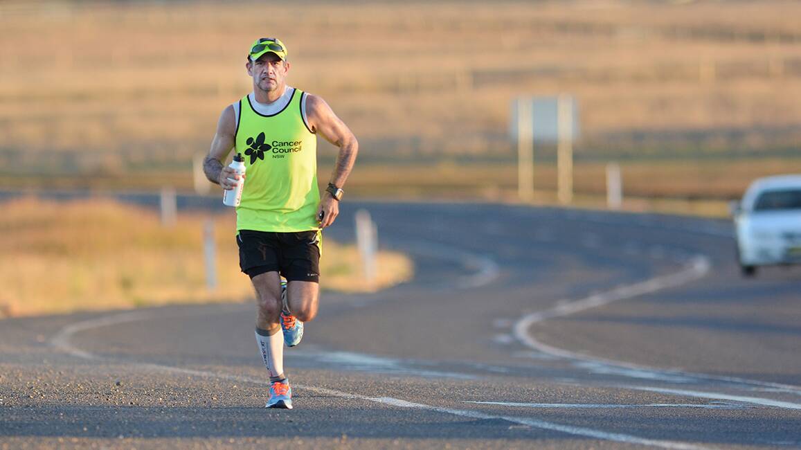CLOSING A CHAPTER: 
Long-distance runner Harald Ulriksen passes through the outskirts of Tamworth yesterday as part of a Sydney-to- Brisbane run in honour of his late wife and father, who died of cancer. Photo: Barry Smith 150514BSF01