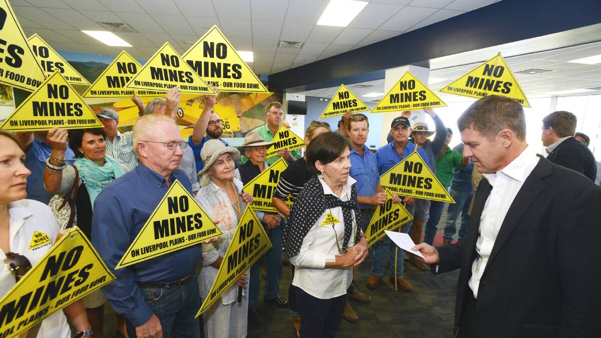 PLEA FOR HELP: Premier Mike Baird accepts a letter from Susan Lyle of the Caroona Coal Action Group begging him to step in and halt Shenhua Watermark’s coalmine on the Liverpool Plains. Photo: Barry Smith 030215BSB15