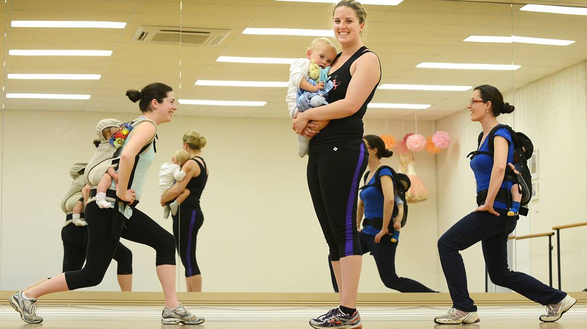 FEEL THE BURN, BABY: Local mums Rebecah Lockart with baby Hannah, Natalie Deacon with Nate, and Beth Townsend with Alexander do light dancing and exercise at Kangatraining New England. Photo: Barry Smith 270814BSA03