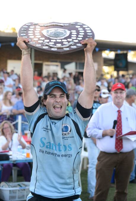 Narrabri captain Matt Schwager holds aloft the Heath Shield to cap a memorable day for the club and him personally. Photo: Barry Smith 130914BSD96