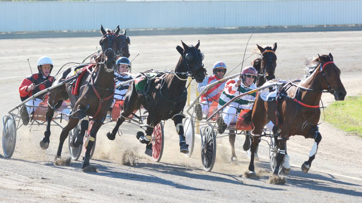 Anthony Varga and Wranglers Rockstar (left) range up to win the first race at Tamworth Paceway yesterday.  Photo: Barry Smith 220514BSC02