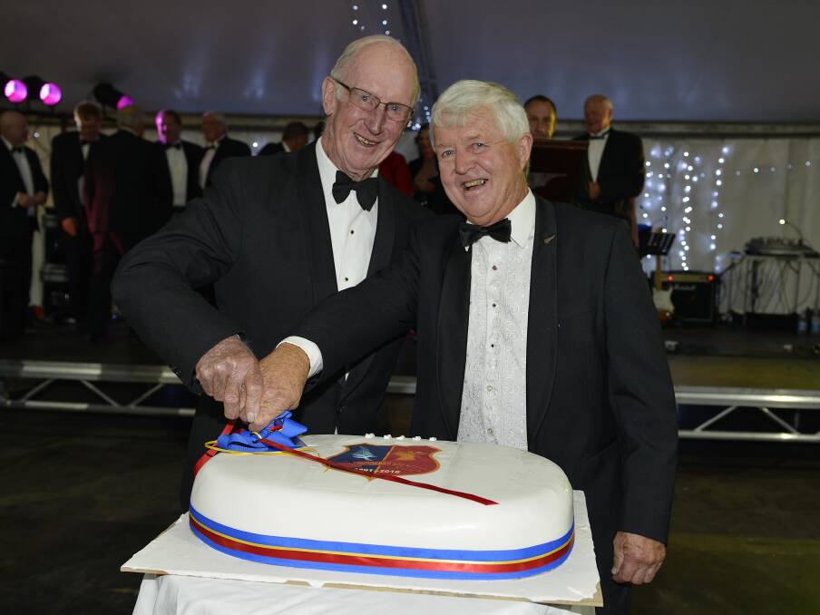 Gunnedah Rugby Club life members Tom Lyle and Mick Hennesey cut the cake at the ball. Picture: Paul Mathews.