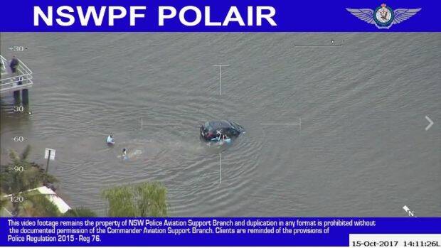 Six police waded into the water to rescue the woman. Photo: NSW Police Force Facebook
